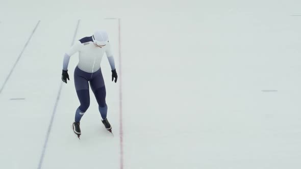 Female Speed Skater Training in Ice Rink