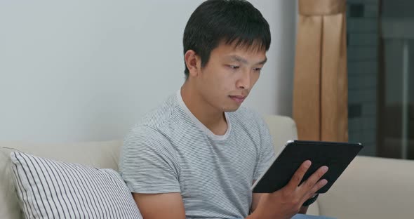 Man use of tablet computer at home