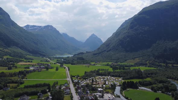 Village and valley in Byrkjelo with pointy mountain Eggjenibba in background - Reverse summer day ae