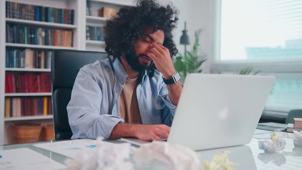 Worried Young Arabian Man Businessman Upset Grabs Face Looking at Laptop Screen