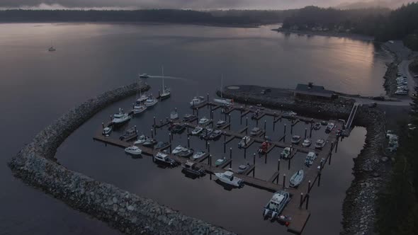 Aerial View of a small secluded town on the Pacific Ocean Coast during a cloudy summer sunrise. Take