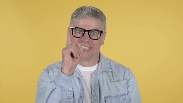 Fighting Casual Senior Man in Anger Isolated on Yellow Background