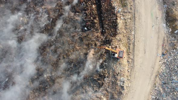 Aerial look down excavator try to save the fire