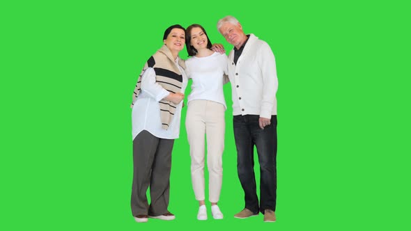 Attractive Young Woman Having Fun with Happy Older Parents on a Green Screen Chroma Key