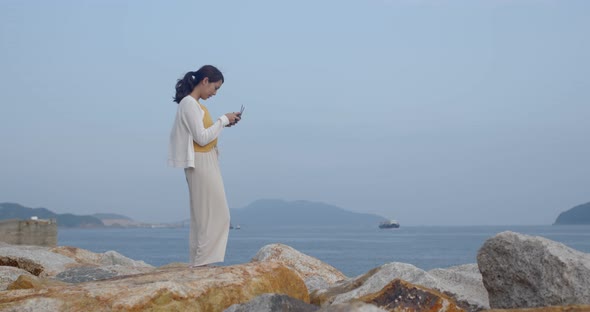 Woman control a drone at the seaside