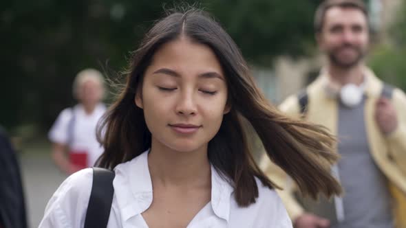 Pretty Asian Female Student Going to Class Outdoor