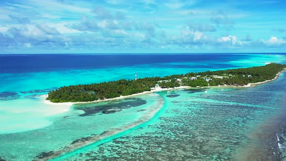 Daytime fly over travel shot of a white paradise beach and aqua blue water background in colourful 4