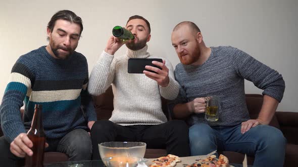 Three Cheerful Friends Male Greet Their Friends By Video Chat