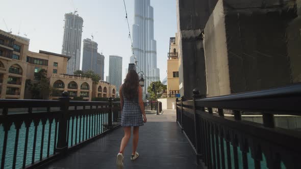 Woman Walking in Luxury Tourist Resort By the Burj Khalifa Skyscraper in Dubai