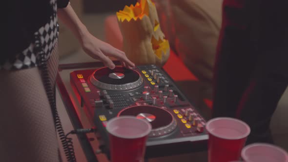 Unrecognizable Woman DJing at Halloween Party