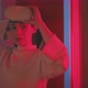 Young woman putting on vr goggles and starts experiencing virtual reality - VideoHive Item for Sale