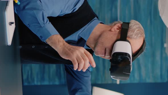 Vertical Video Retired Man Experiencing Virtual Reality Using Vr Headset in Living Room