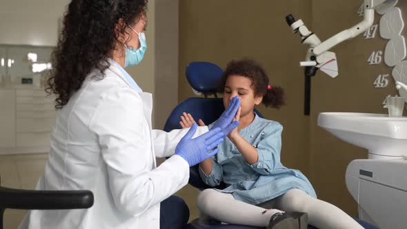 Frmale Dentist Playing Clapping Game with Patient