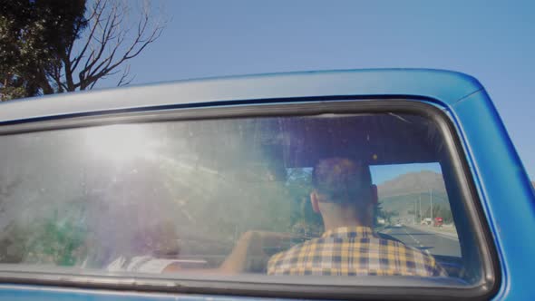 Young couple on a road trip in their pick-up truck