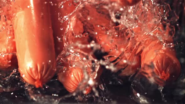 Super Slow Motion Sausages Fall on the Water with Splashes