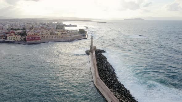 Cinematic Aerial Drone sunset shot of lighthouse in the old Venetian port of Chania