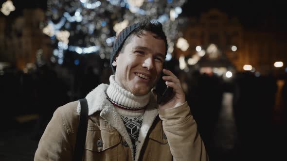 A Man Congratulating Someone on Phone at Xmas Night