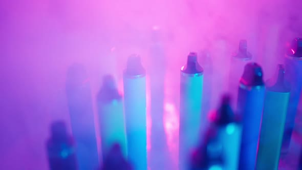 ECigarettes and Vapes with Smoke in Neon Lighting