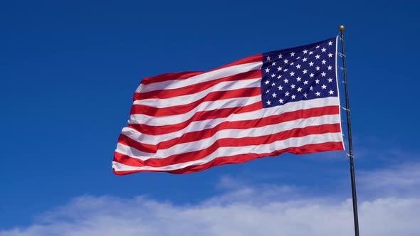 USA Flag Waving in the Wind Against a Cloudless Blue Sky