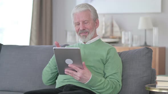 Old Man Doing Video Chat on Tablet at Home