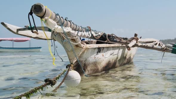 Traditional African Fishing Boat Stranded in Sand on Beach at Low Tide Zanzibar