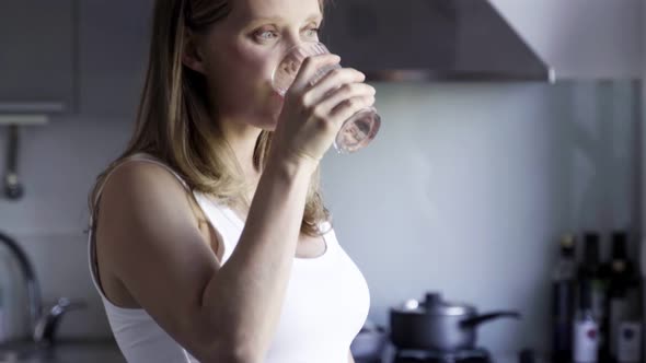 Beautiful Pregnant Woman Drinking Water From Glass