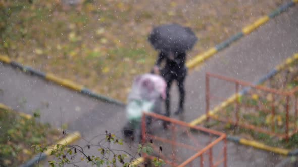 Woman with child outside on snowy autumn day