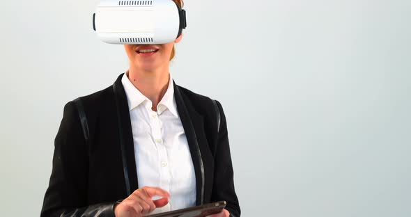 Business woman using virtual reality headset and digital tablet