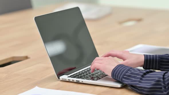 Businesswoman Typing on Laptop at Work