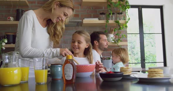 Family preparing food on worktop in kitchen at comfortable home 4k