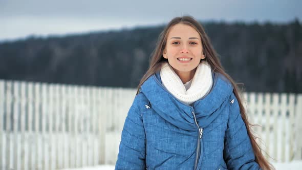 Young Pretty Woman Laughing and Running at Winter Park