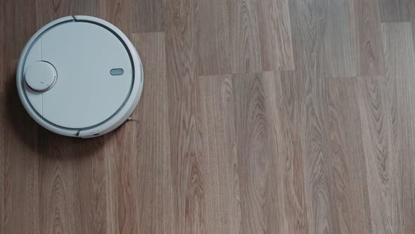 Robot vacuum cleaner performs automatic cleaning of the apartment. Smart Home.