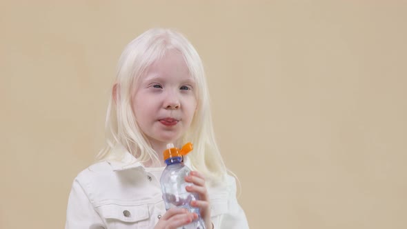 Cute Little Albino Girl Drinks Water and Shows Thumb Up in Approval