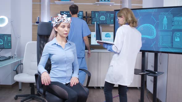 Neuro Science Female Doctor and Her Assistant in Modern Facility