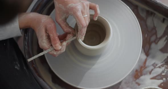 Top View Ceramist Sculpts a Jug on a Potter's Wheel the Potter Makes Even Edge of a Clay Jar Making