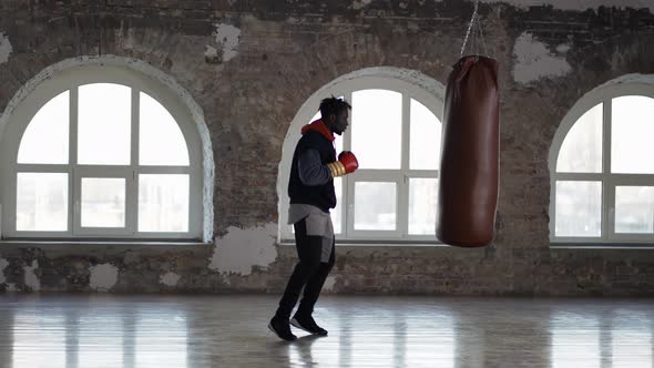 Full Length of a Boxer Training at Boxing Studio in Gloves at Loft Studio