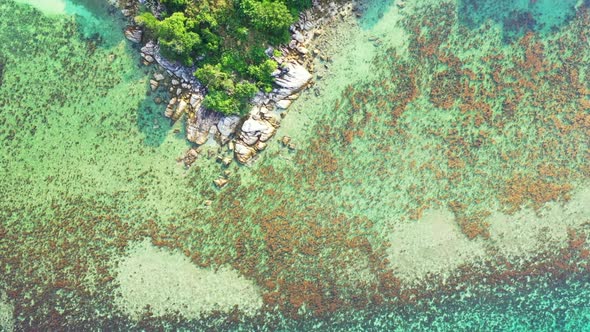 Aerial drone shot landscape of idyllic lagoon beach adventure by blue ocean with white sand backgrou