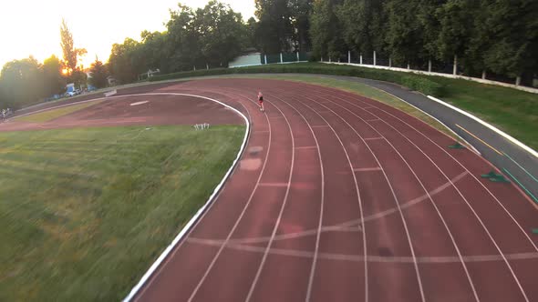 Athletes jogging, training at the stadium