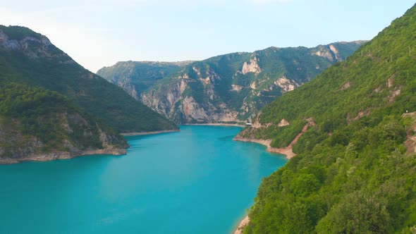 Aerial view of lake Piva with turquoise water on rocky canyon in Montenegro