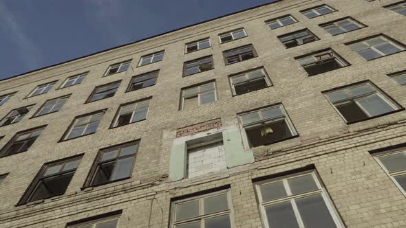 The old industrial building from the Soviet Union in very bad condition , with broken Windows