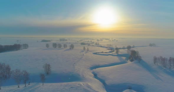 Aerial View of Cold Winter Landscape Arctic Field Trees Covered with Frost Snow Ice River and Sun