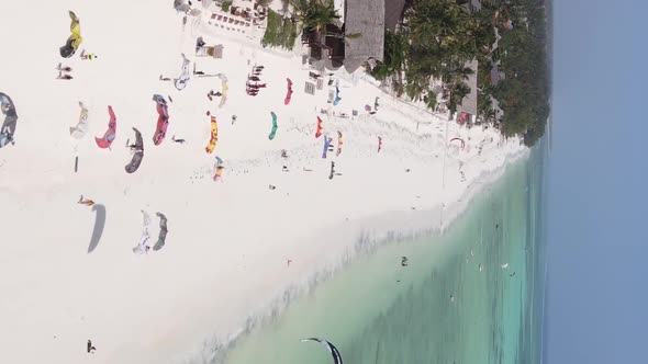 Vertical Video Kitesurfing Near the Shore of Zanzibar Tanzania Aerial View