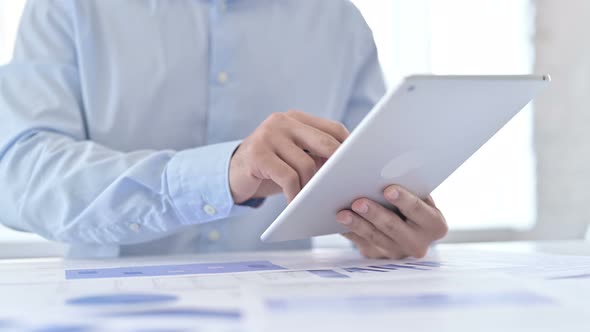 Close Up of Young Guy Hands Working on Documents and Tablet