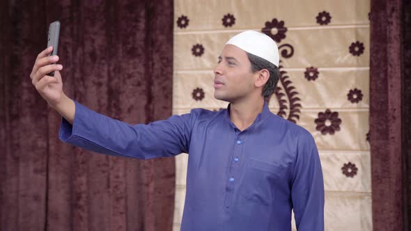 Happy Muslim man talking on a video call