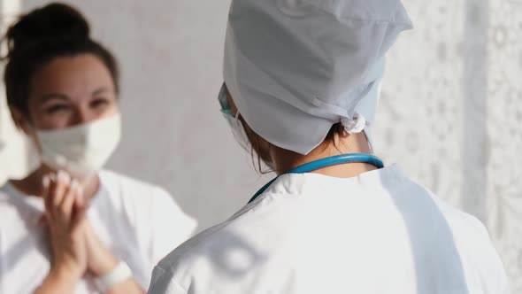 Smiling Young Female Patient with Female Doctor in White Uniform Thanking for Help or Feeling