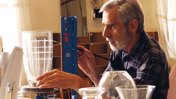 Glassblower working on a glass vase