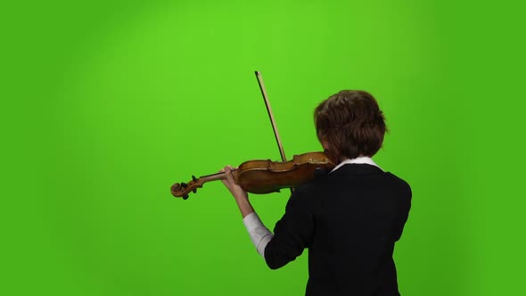 Woman Stands with Her Back and Plays the Violin