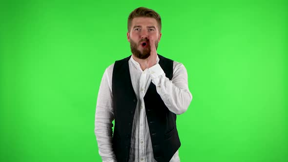 Man Screams Calling Someone on a Green Screen at Studio.