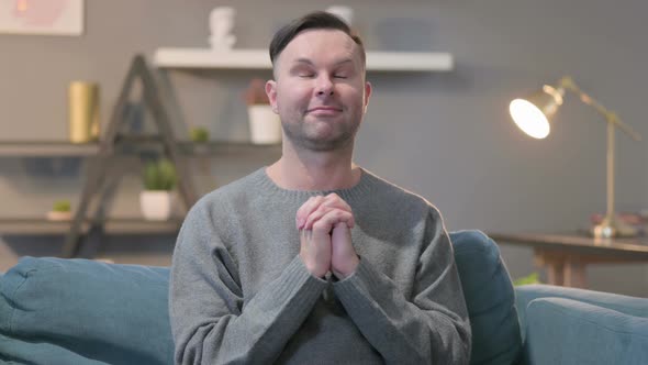 Portrait of Casual ManPraying with Hands Crossed