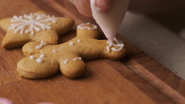 Decoration Process of Christmas Cookies in the Shape of Gingerbread Men with Icing